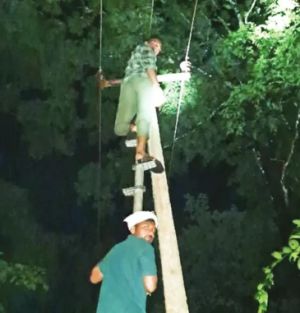 HESCOM staff who don't stop working even when it's dark!